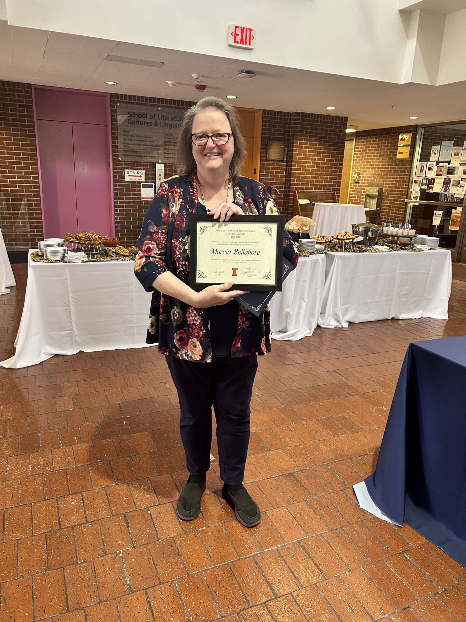 Marcia Bellafiore holding award