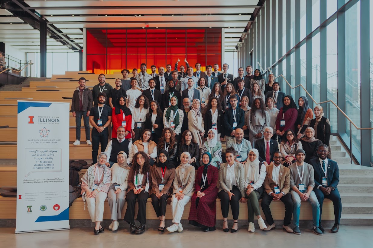 Participants of debate championship pose for group photo on bleachers