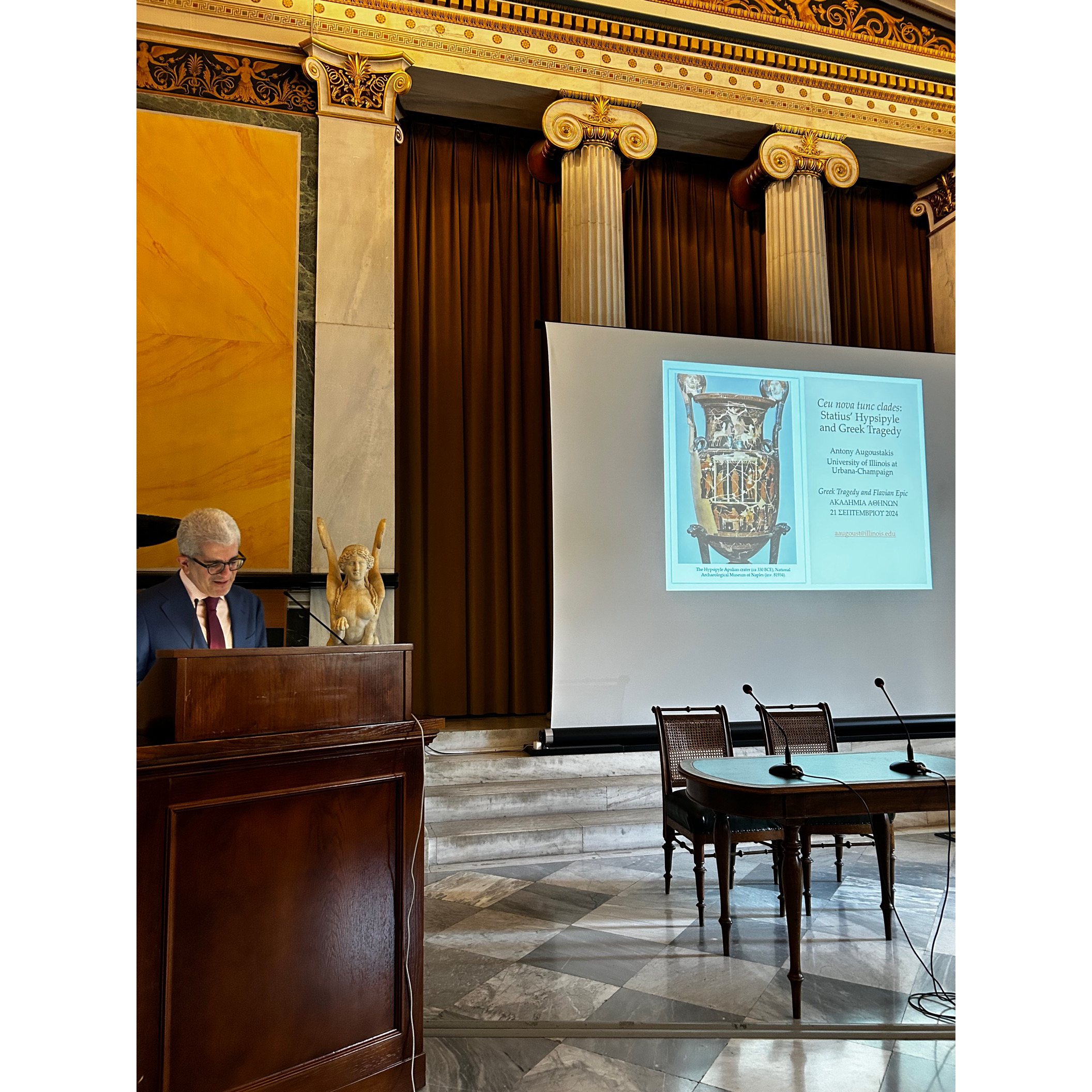 Professor standing at podium giving lecture at Academy of Athens