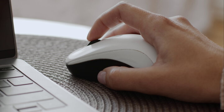 Close up of hand using wireless computer mouse