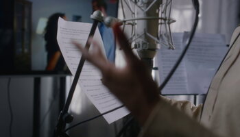 Voice actress holding cue sheet
