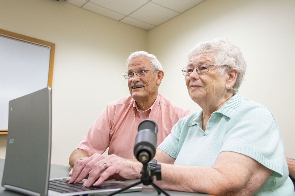 Couple recording with laptop