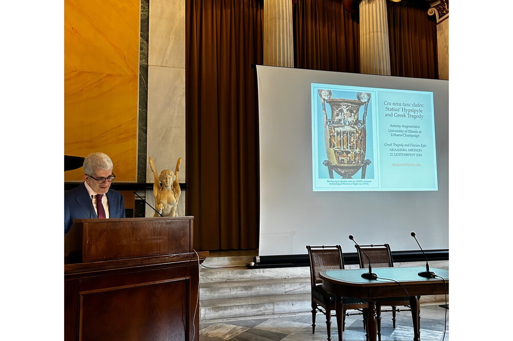 Professor standing at podium giving lecture at Academy of Athens