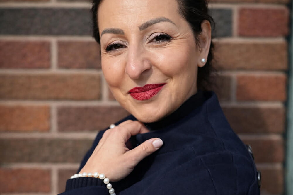 Woman in front of brick wall