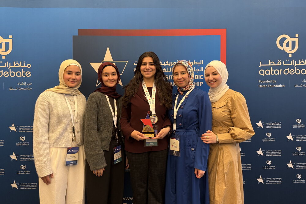 Arabic debate team poses with award