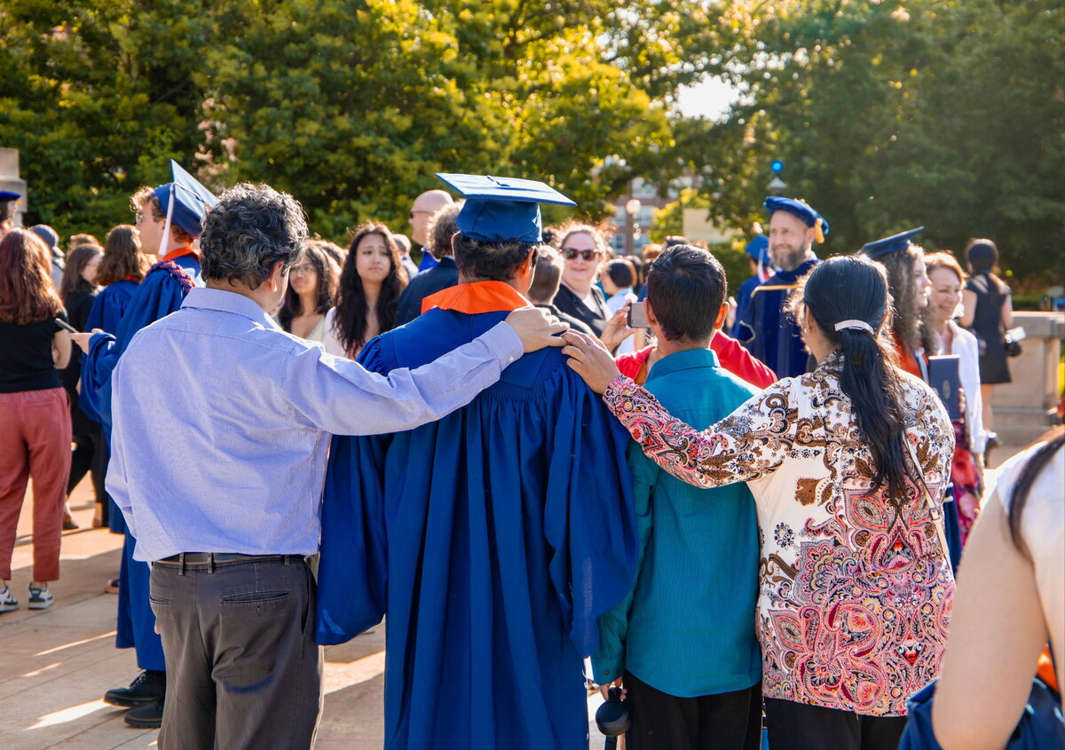 Student being hugged by family