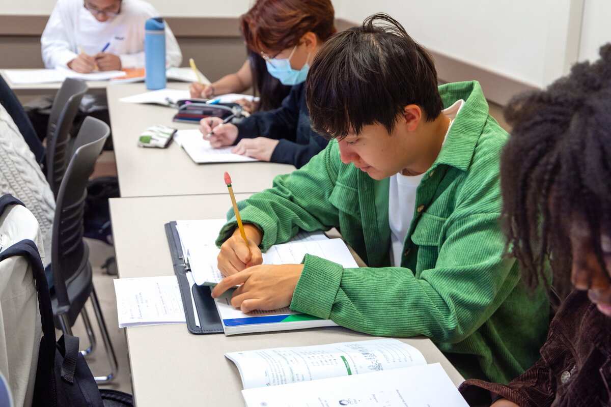 Student taking notes in classroom