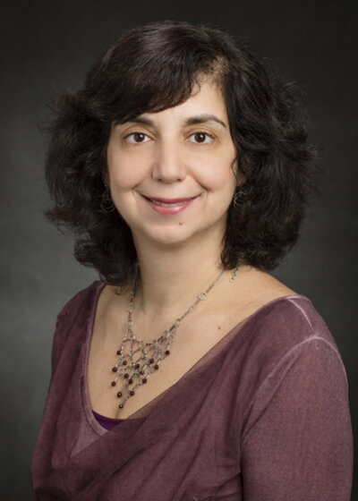 Headshot of smiling woman with short dark hair