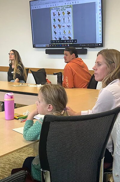 Parent and daughter listening to instructor