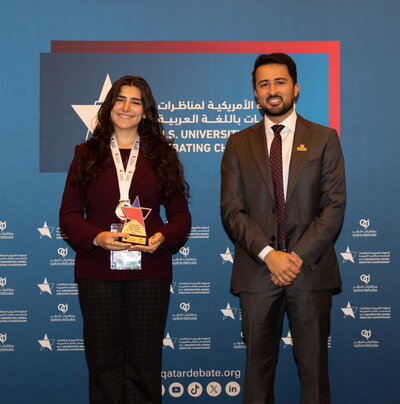Student holding award