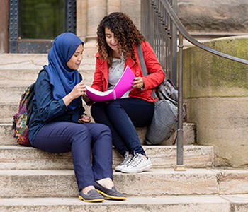 Two students studying outside
