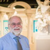 Smiling man in glasses with white hair and beard in Spurlock Museum