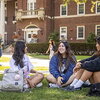 Three students sit on Quad
