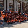 Large group of children in matching bright orange t-shirts