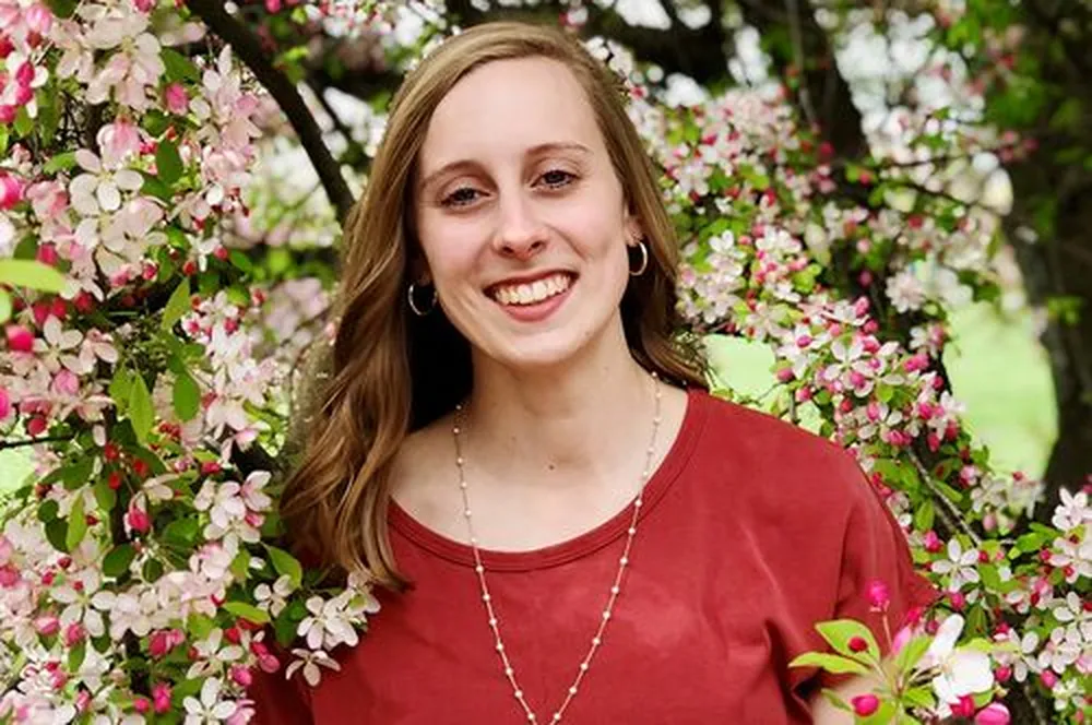 Grace Maloney Smiling woman in red shirt