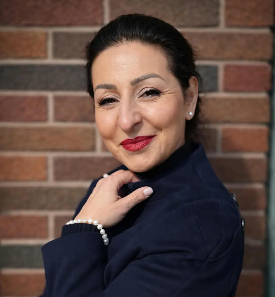 Woman in front of brick wall