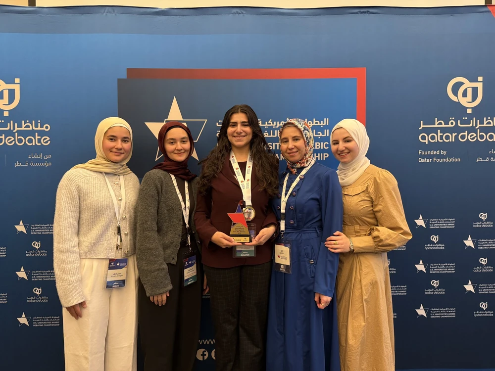 Arabic debate team poses with award
