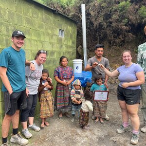 Students hand off house keys to family during volunteer trip