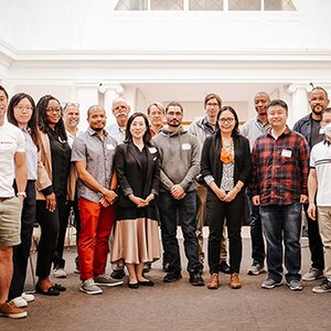 Group of new faculty members pose for picture at event 