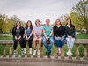 FLTE students and instructor sit on stone railing