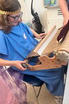 Student operating old-style loom