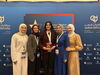 Arabic debate team poses with award