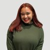 Smiling young redheaded woman in green sweater